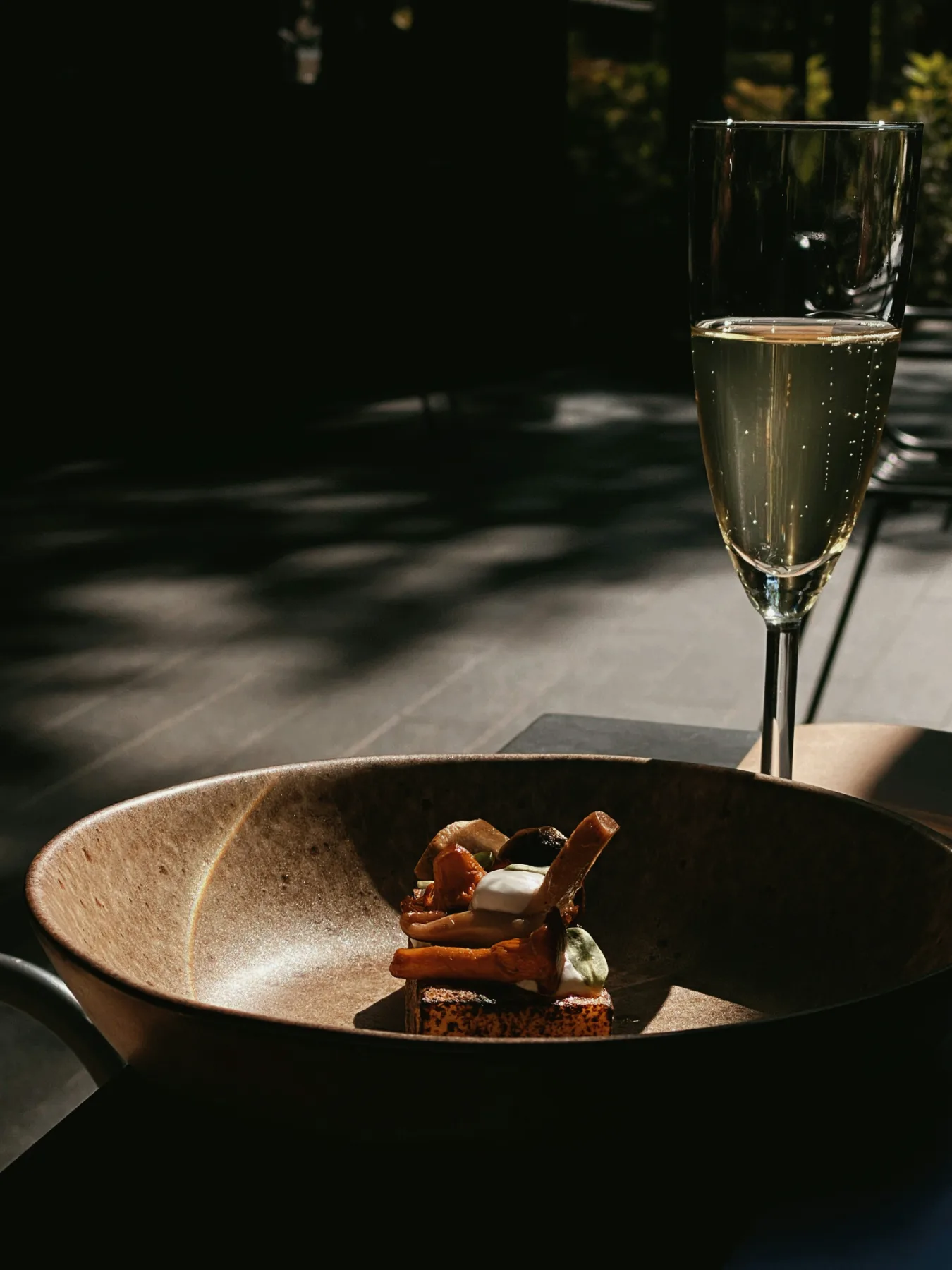 A canap&eacute; served beside a glass of champagne