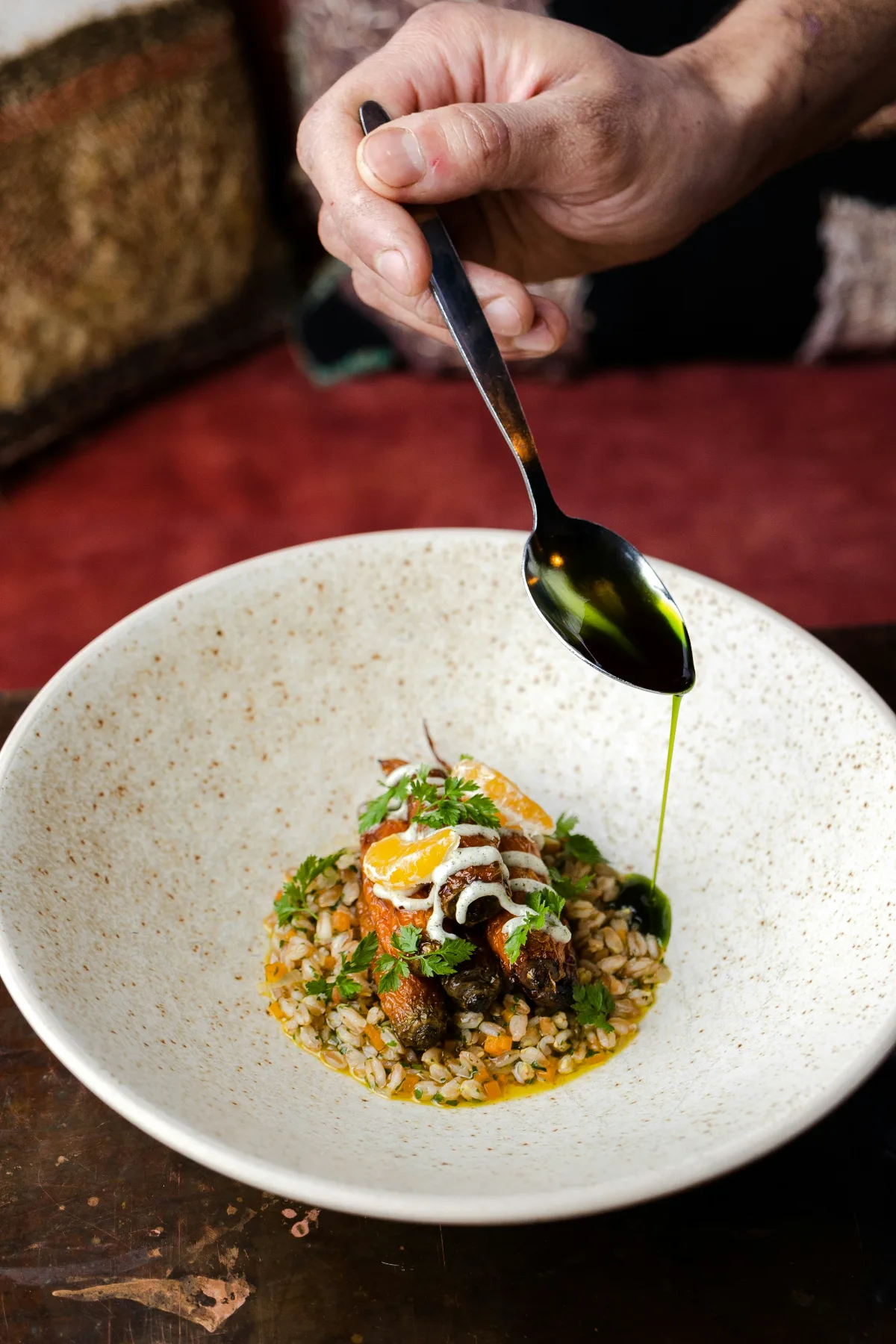 Herb oil spooned over a vegetable course