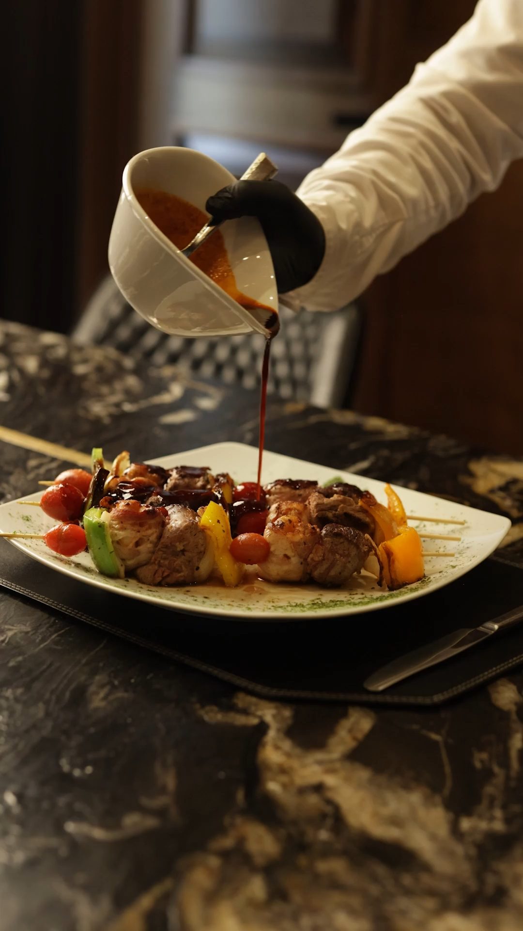 Sauce poured over a plated course